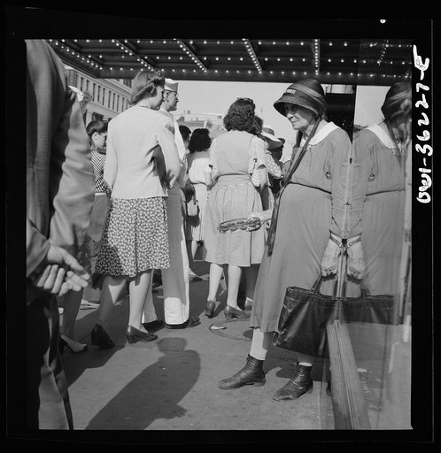 Washington, D.C. An American rescue society worker soliciting funds from a crowd of people waiting to get into a movie