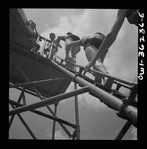 Glen Echo, Maryland. A line of people waiting to get into the swimming pool at the Glen Echo amusement park on a hot day