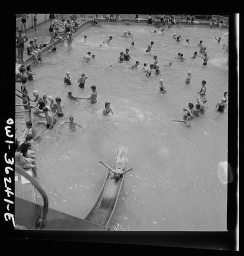 Untitled photo, possibly related to: Glen Echo, Maryland. A bather sliding down the waterslide at the Glen Echo swimming pool