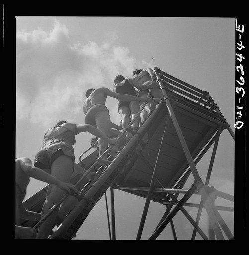 Glen Echo, Maryland. Climbing the ladder to the sliding board at the swimming pool in the Glen Echo amusement park