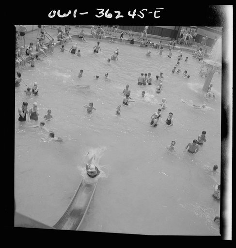 Glen Echo, Maryland. A bather sliding down the waterslide at the Glen Echo swimming pool