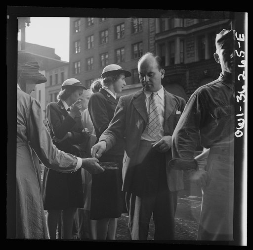 Washington, D.C. A man giving money to a worker for the American Rescue Society