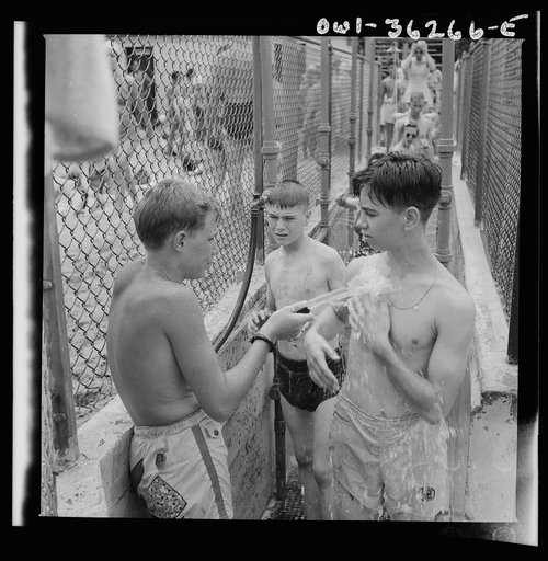 Glen Echo, Maryland. An attendant washing the sand from people who are going to the swimming pool for the beach at the Glen Echo amusement park