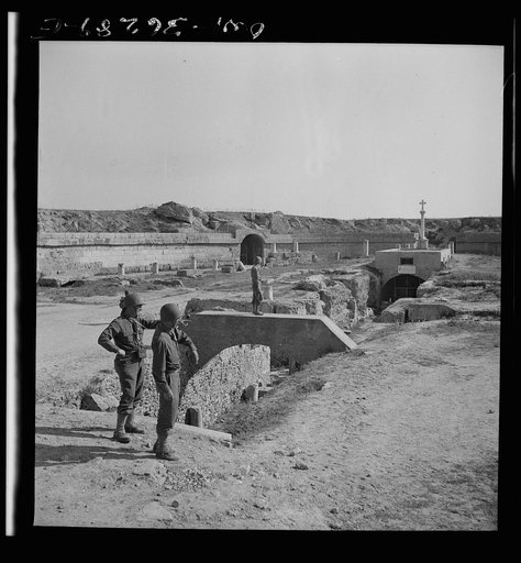 Carthage, Tunisia. American Army chaplains inspecting the ruins of the Roman arena where Christian martyrs were thrown to the lions. The altar later erected on the site had been used as a bivouac by German troops