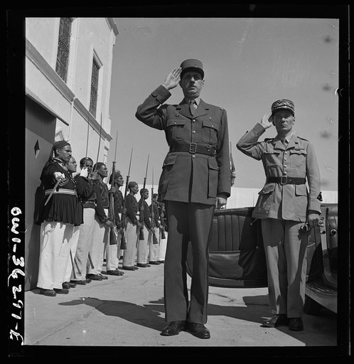 Carthage, Tunisia. General de Gaulle, accompanied by General Mast, saluting as the band plays Marseillaise outside the summer palace of the bey of Tunis