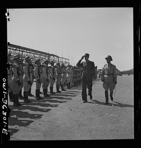 Tunis, Tunisia. General de Gaulle saluting the guard of honor drawn up at the airport to greet him on the occasion of his visit
