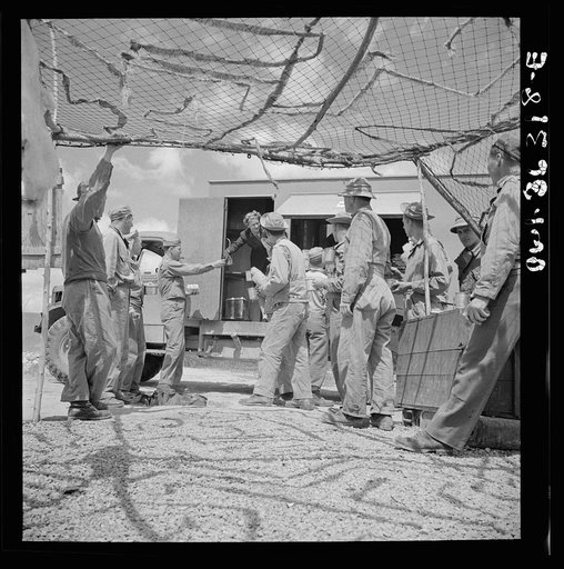 Constantine (vicinity), Algeria. Red Cross clubmobile serving refreshments to an anti-aircraft gun crew stationed in an outlying post