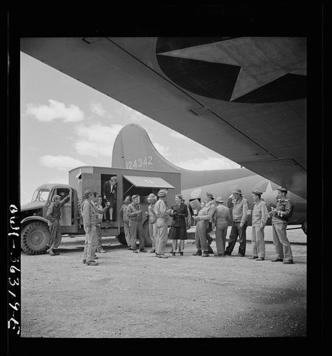 Constantine (vicinity), Algeria. A Red Cross clubmobile serving doughnuts and coffee to the crew of a bomber just returned to the airport from a dangerous mission