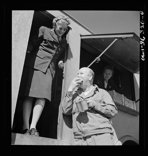 Untitled photo, possibly related to: Constantine (vicinity), Algeria. Red Cross clubmobile serving refreshments to an anti-aircraft gun crew stationed in an outlying post