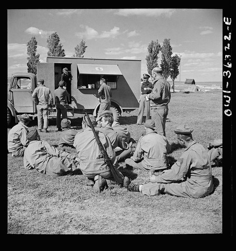 Untitled photo, possibly related to: Constantine (vicinity), Algeria. Red Cross clubmobile serving refreshments to an anti-aircraft gun crew stationed in an outlying post