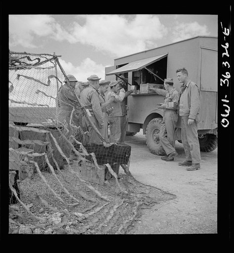 Untitled photo, possibly related to: Constantine (vicinity), Algeria. Red Cross clubmobile serving refreshments to an anti-aircraft gun crew stationed in an outlying post