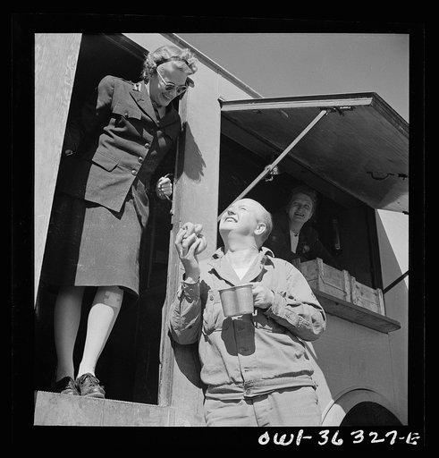 Untitled photo, possibly related to: Constantine (vicinity), Algeria. Red Cross clubmobile serving refreshments to an anti-aircraft gun crew stationed in an outlying post