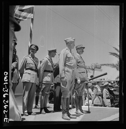 Untitled photo, possibly related to: Tunis, Tunisia. French troops passing the reviewing stand in the Allied victory parade along Avenue Gambetta as American planes fly overhead in a show of Allied might