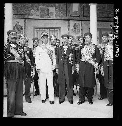 Untitled photo, possibly related to: Carthage, Tunisia. General de Gaulle, the Bey of Tunis and General Mast in the courtyard of the bey's summer palace