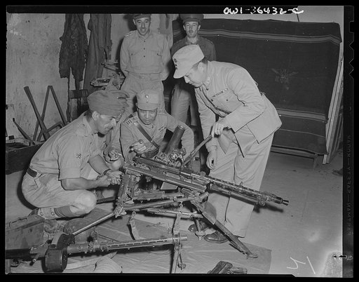 Tunis, Tunisia. Major Hwang (center) with General Hoo and British ordnance officers inspecting a captured German anti-tank gun