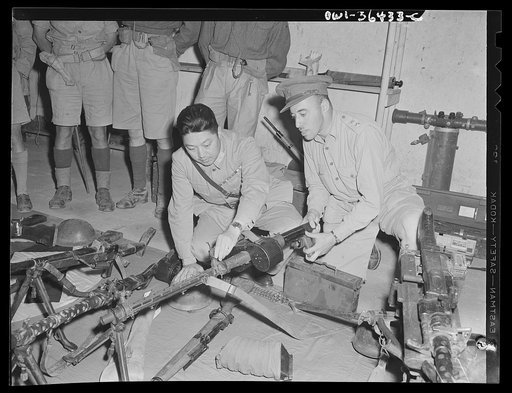 Tunis, Tunisia. Major General H.C. Hoo, tank expert and head of the Chinese military mission to North Africa, inspecting captured German guns with Lieutenant B. Zeff, British ordnance officer
