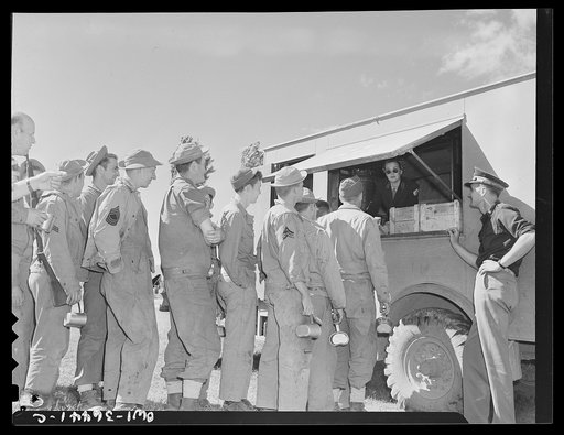 Constantine (vicinity), Algeria. A Red Cross clubmobile serving refreshments to troops in an outlying bivouac area