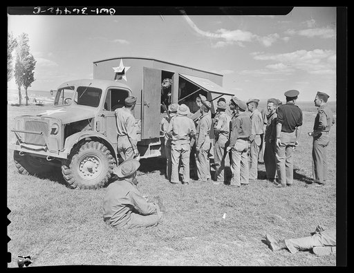Constantine (vicinity), Algeria. A Red Cross clubmobile serving refreshments to troops in an outlying bivouac area