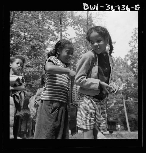 Bear Mountain, New York. Interracial activities at Camp Fern Rock, where children are aided by the Methodist Camp Service. Girls adjusting each others' packs for a hike