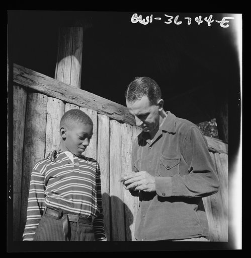 Southfields, New York. Interracial activities at Camp Nathan Hale, where children are aided by the Methodist Camp Service. Mr. Lewis Traver, the director, giving instruction to one of the campers