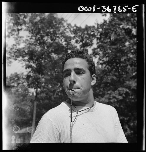 Southfields, New York. Interracial activities at Camp Nathan Hale, where children are aided by the Methodist Camp Service. The town crier, Danny Poocchiari