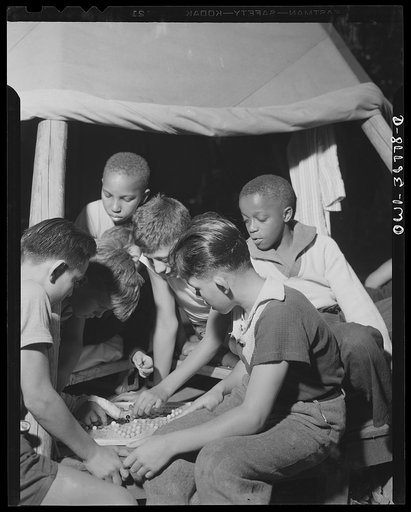 Southfields, New York. Interracial activities at camp Nathan Hale, where children are aided by the Methodist Camp Service. A game of Chinese checkers is of interest to the campers