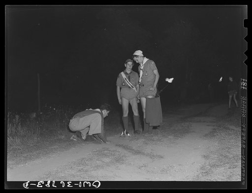 Tusten, New York. Interracial activities at Camp Brooklyn, where children are aided by the Methodist Camp Service. The order of the Arrow of the Boy Scouts of America, supervising the extinguishing of the camp fire