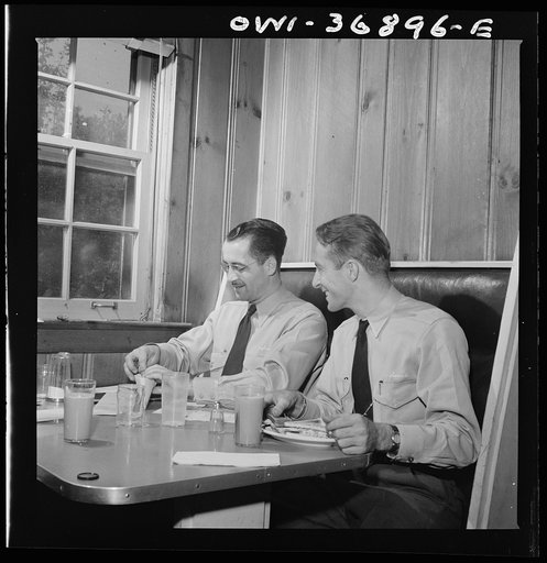 New Bedford, Pennsylvania. Drivers of Greyhound buses going from Gettysburg to Pittsburgh, Pennsylvania, checking their tickets while eating lunch at the rest stop