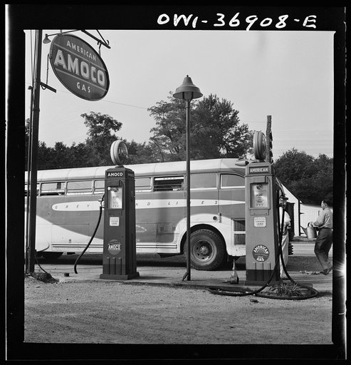A Greyhound bus that has been stopped while the driver fills the water tank at a gas station on the road between Gettysburg and Pennsylvania