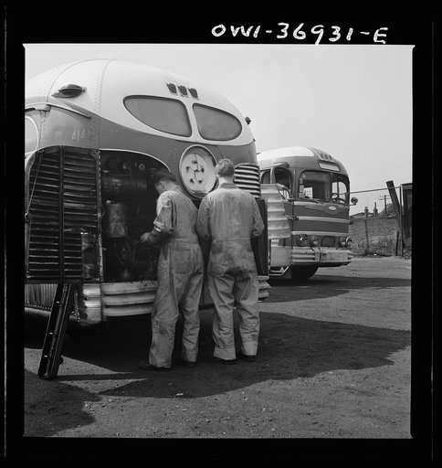 Untitled photo, possibly related to: Pittsburgh, Pennsylvania. Mechanics working on a bus parked outside the Greyhound garage because there is no room inside