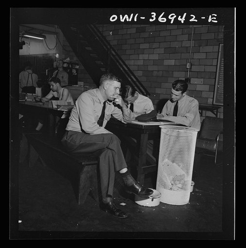 Untitled photo, possibly related to: Pittsburgh, Pennsylvania. Greyhound bus drivers writing out trip reports in the garage