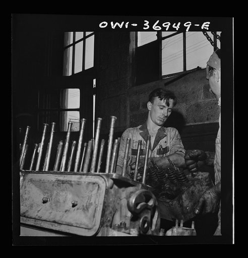 Untitled photo, possibly related to: Pittsburgh, Pennsylvania. Mechanic working on a bus engine at the garage