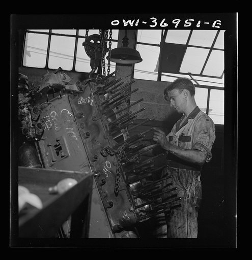 Untitled photo, possibly related to: Pittsburgh, Pennsylvania. Mechanic working on a bus engine at the garage