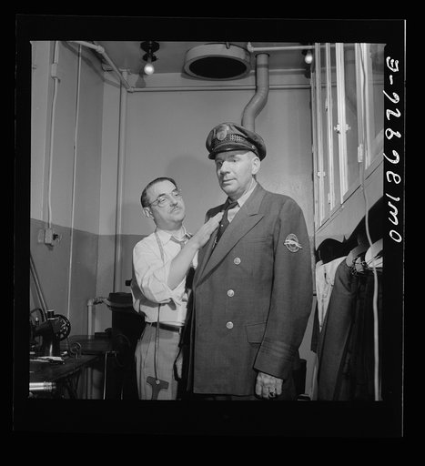 Pittsburgh, Pennsylvania. A tailor fitting a coat at the shop maintained in the Greyhound garage. Drivers pay a dollar a month and can have clothes altered, fitted, and pressed at any time