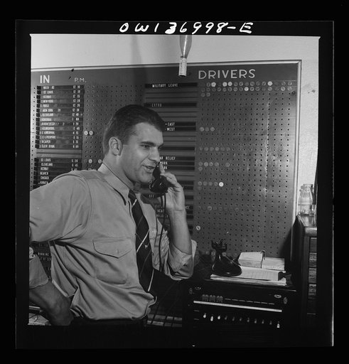 Untitled photo, possibly related to: Pittsburgh, Pennsylvania. Dispatcher at the Greyhound garage. The board in the background shows drivers and equipment assigned to Pittsburgh and their whereabouts at a glance
