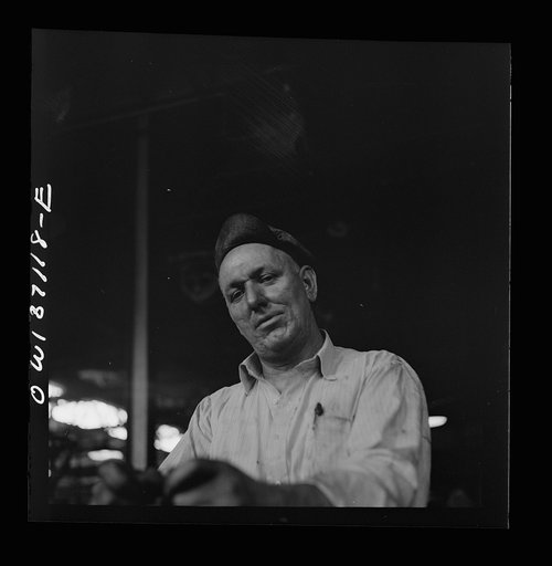 Untitled photo, possibly related to: Pittsburgh, Pennsylvania. A mechanic in the machine shop at the Greyhound garage