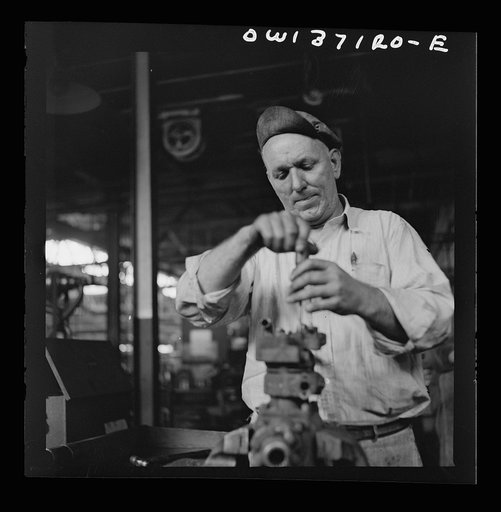 Untitled photo, possibly related to: Pittsburgh, Pennsylvania. A mechanic in the machine shop at the Greyhound garage