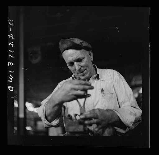 Untitled photo, possibly related to: Pittsburgh, Pennsylvania. A mechanic in the machine shop at the Greyhound garage