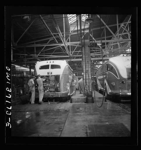 Untitled photo, possibly related to: Pittsburgh, Pennsylvania. Some Greyhound buses which are placed over pits for repairs at the garage