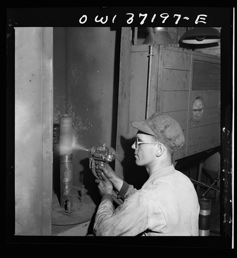 Pittsburgh, Pennsylvania. A mechanic metalizing a part in the machine shop at the Greyhound garage. This is one of the new salvage operations for worn parts undertaken since the war