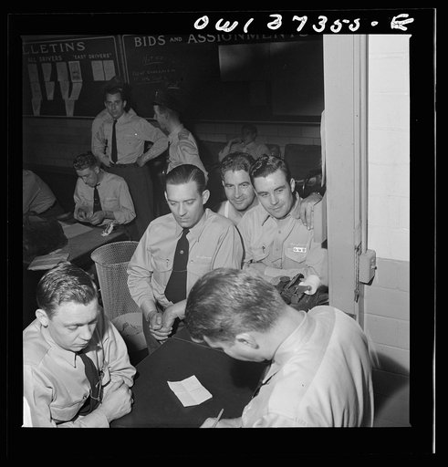 Pittsburgh, Pennsylvania. Greyhound bus drivers getting their assignments at the dispatcher's desk in the garage