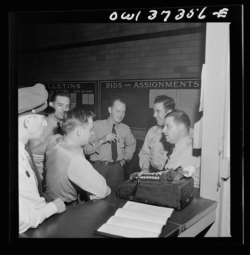 Pittsburgh, Pennsylvania. Greyhound bus drivers at the dispatcher's desk in the garage
