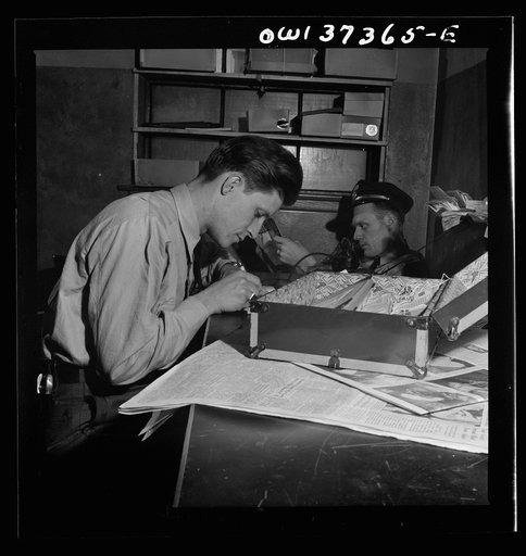 Columbus, Ohio. A Greyhound bus driver making out a trip report in the driver's room
