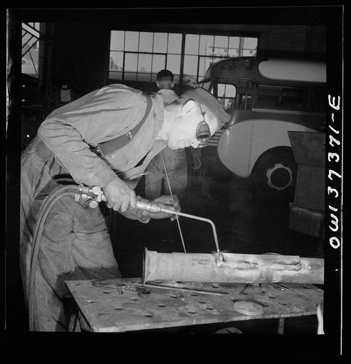 Untitled photo, possibly related to: Columbus, Ohio. Fixing a bus part at the Greyhound garage