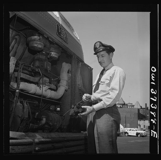 Columbus, Ohio. Randy Pribble, a bus driver for the Pennsylvania Greyhound Lines, Incorporated, checking the oil in a bus before taking it out on a run