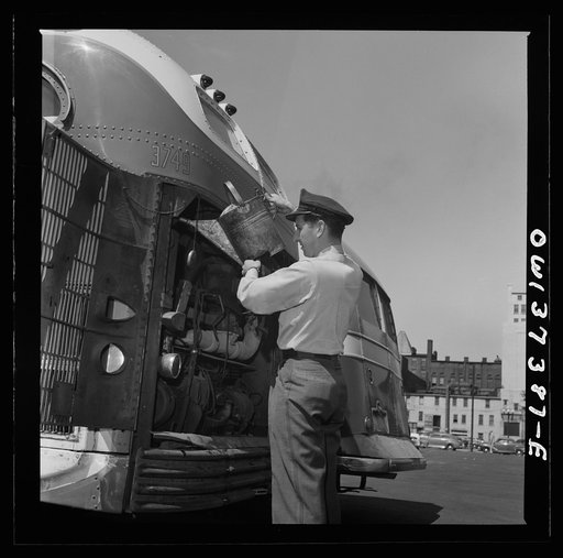 Columbus, Ohio. Randy Pribble, a bus driver for the Pennsylvania Greyhound Lines, Incorporated, putting water into a bus before taking it out on a run