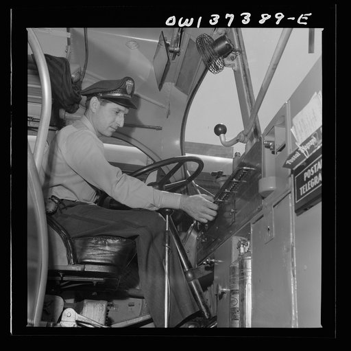 Columbus, Ohio. Randy Pribble, a driver for the Pennsylvania Greyhound Lines, Incorporated, checking the lights on a bus before taking it out on a run