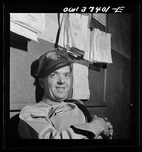 Columbus, Ohio. Clem Carson, a Greyhound bus driver waiting for an assignment in the drivers' room to go on duty
