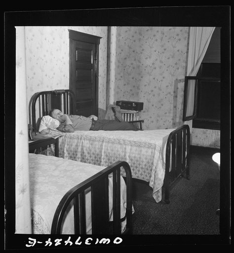 Pittsburgh, Pennsylvania. Hotel room where Clem Carson, a Greyhound driver, lives and which he shares with another bus driver. They each pay six dollars a week