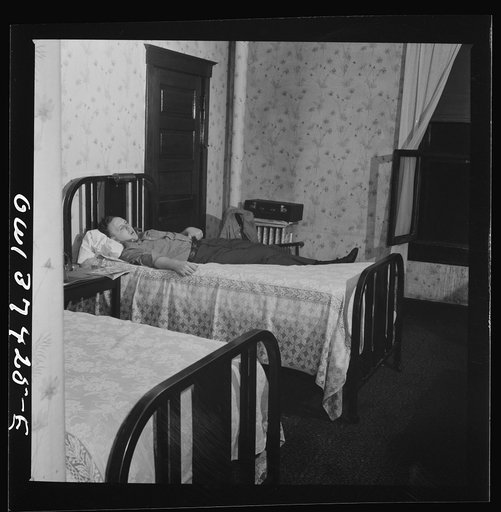 Untitled photo, possibly related to: Pittsburgh, Pennsylvania. Hotel room where Clem Carson, a Greyhound driver, lives and which he shares with another bus driver. They each pay six dollars a week